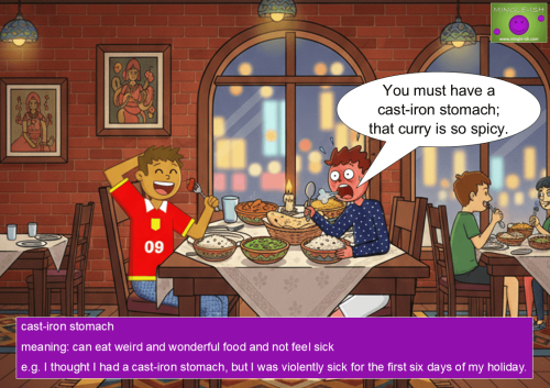 A cartoon illustration for the idiom "cast-iron stomach" set in a cozy curry house. A character in a red "09" shirt happily eats a spicy meal, while his friend in a blue polka-dot shirt reacts to the heat with sweat and a shocked expression. The image includes a speech bubble and a purple box defining the idiom with a practical example.